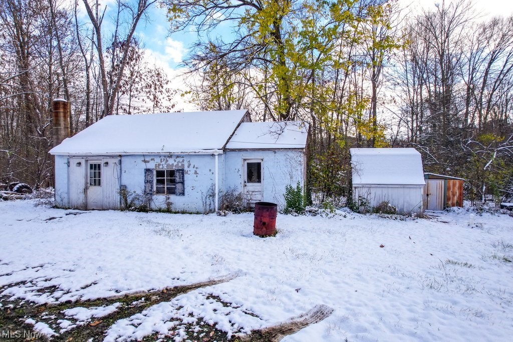 7456 Jackson Road Chagrin Falls, OH 44023 - Photo 6 of 30 Snow covered rear of property featuring an outdoor structure