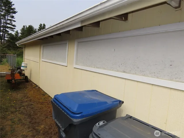 a backyard of a house with table and chairs