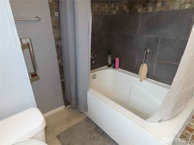 a bathroom with a tub and sink