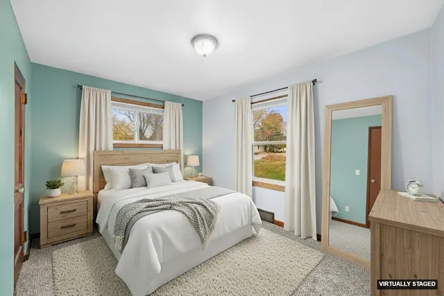 a bedroom with a large bed and a window