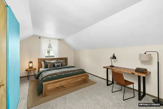 a bedroom with furniture and a lamp