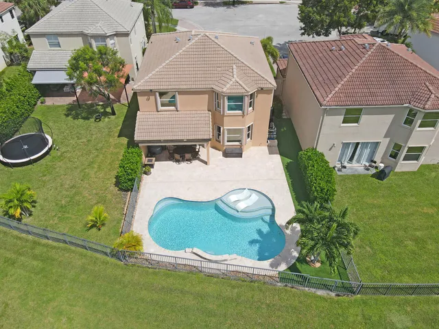an aerial view of a house with a swimming pool
