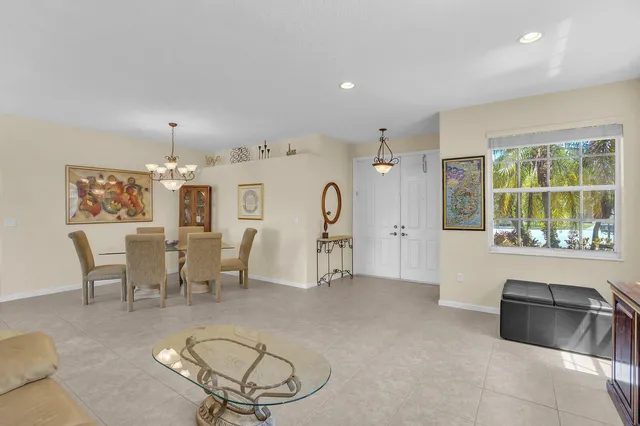 a view of a lake with a swimming pool and a chairs