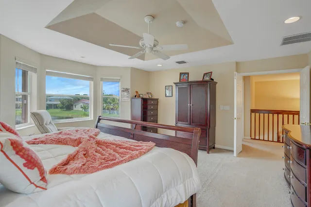 a view of a house with a small yard and wooden fence
