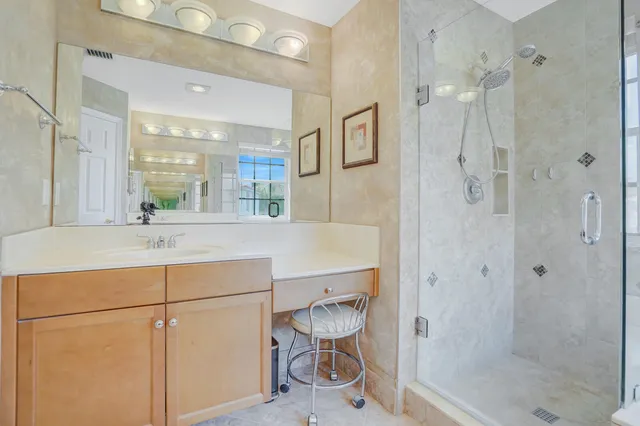 a front view of a house with a garden and plants