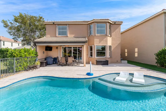 an aerial view of residential houses with outdoor space and lake view