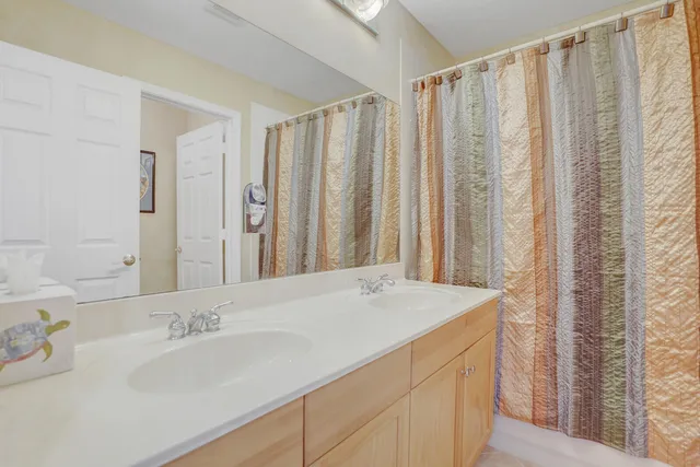 an aerial view of residential houses with outdoor space and lake view