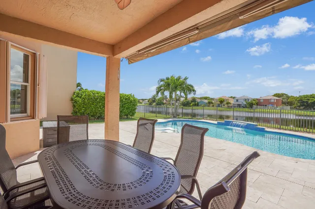 a front view of a house with a garden and plants