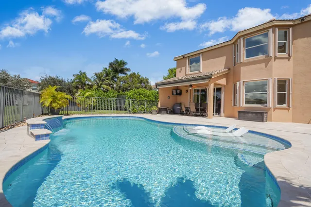 an aerial view of a house with a lake