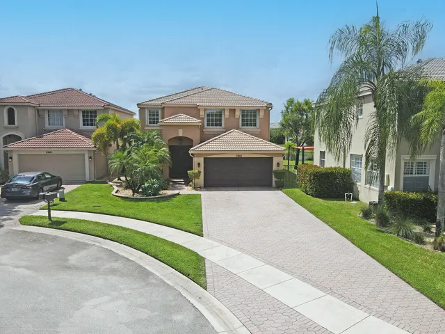 an aerial view of a swimming pool a yard and outdoor seating