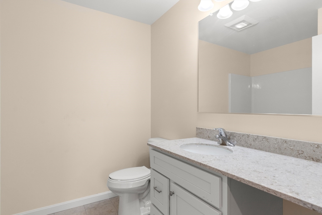 86 Ferry Road Salisbury, MA 01952 - Photo 16 of 28 a bathroom with a granite countertop sink a toilet and a mirror