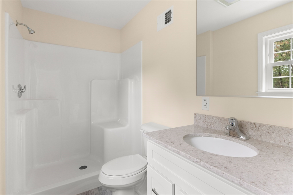 86 Ferry Road Salisbury, MA 01952 - Photo 17 of 28 a bathroom with a granite countertop sink toilet a mirror and shower