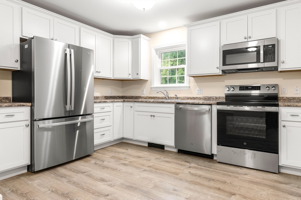 86 Ferry Road Salisbury, MA 01952 - Photo 9 of 28 a kitchen with stainless steel appliances a refrigerator sink and microwave