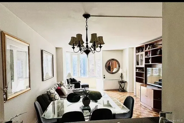 a view of a dining room with furniture and chandelier