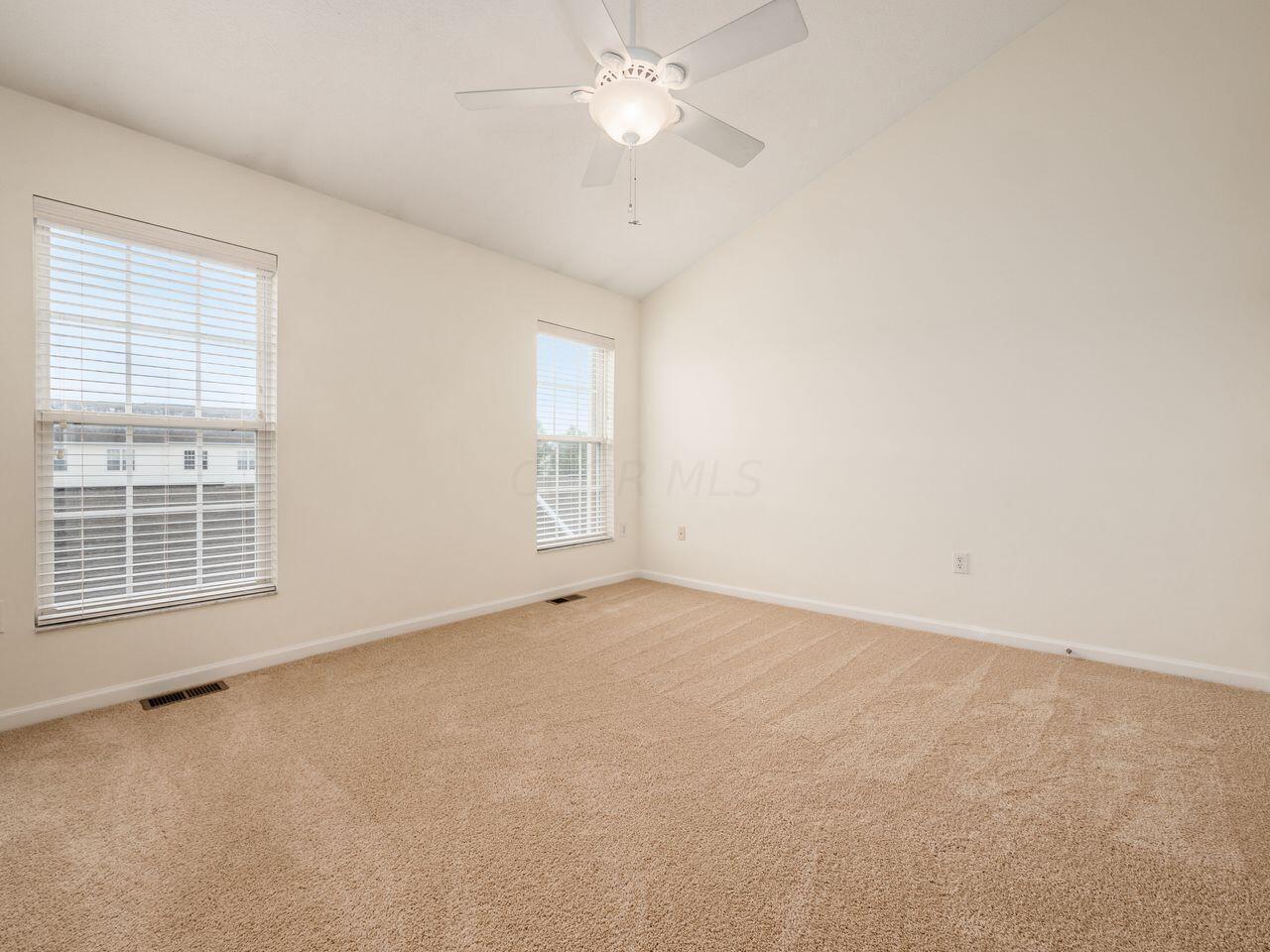 6305 Needletail Road, Unit 25 Columbus, OH 43230 - Photo 18 of 49 Primary bedroom features new carpet and vaulted ceilings.