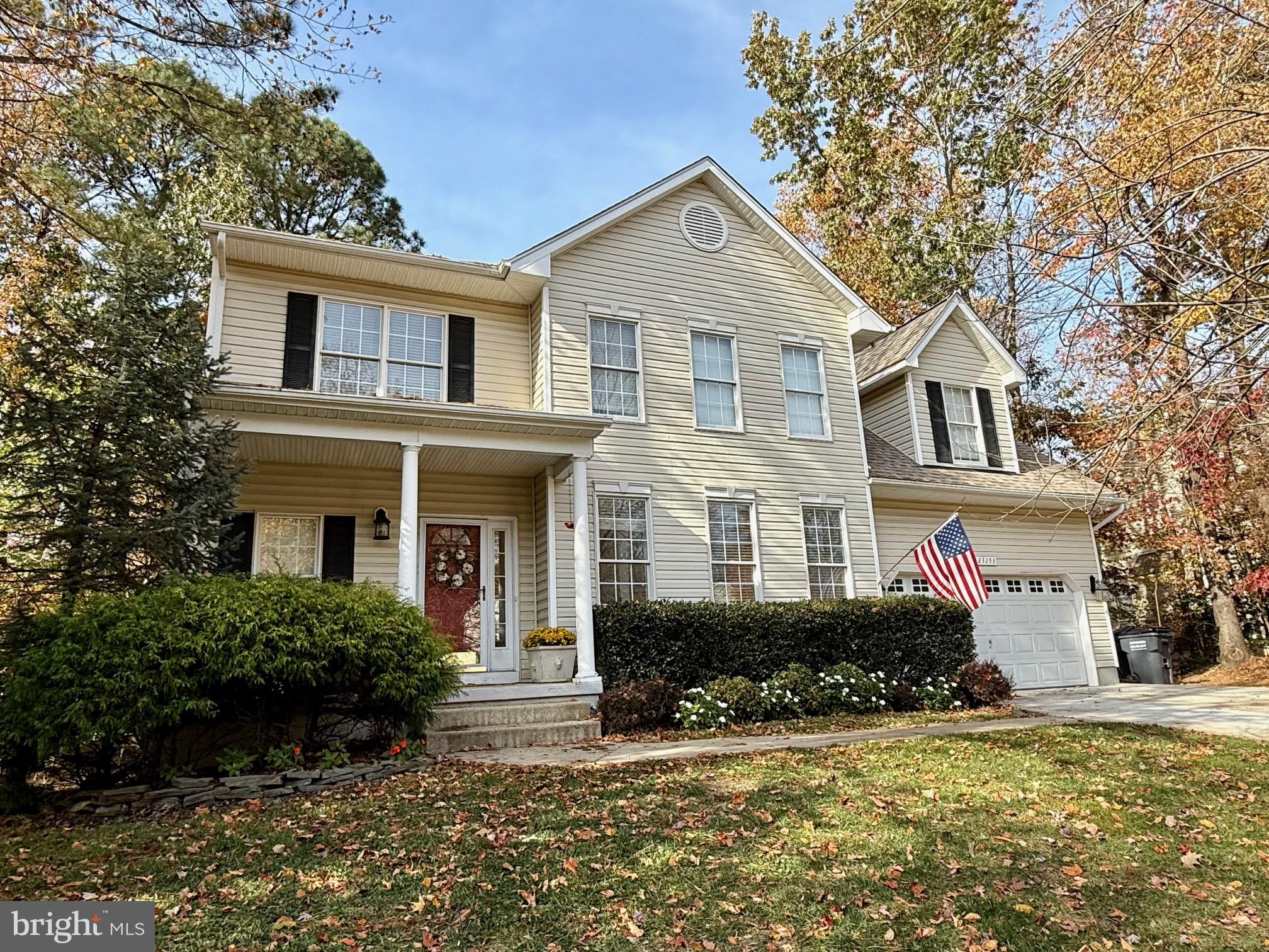23293 Misty Pond Lane California, MD 20619 - Photo 1 of 35 a front view of a house with a yard and garage