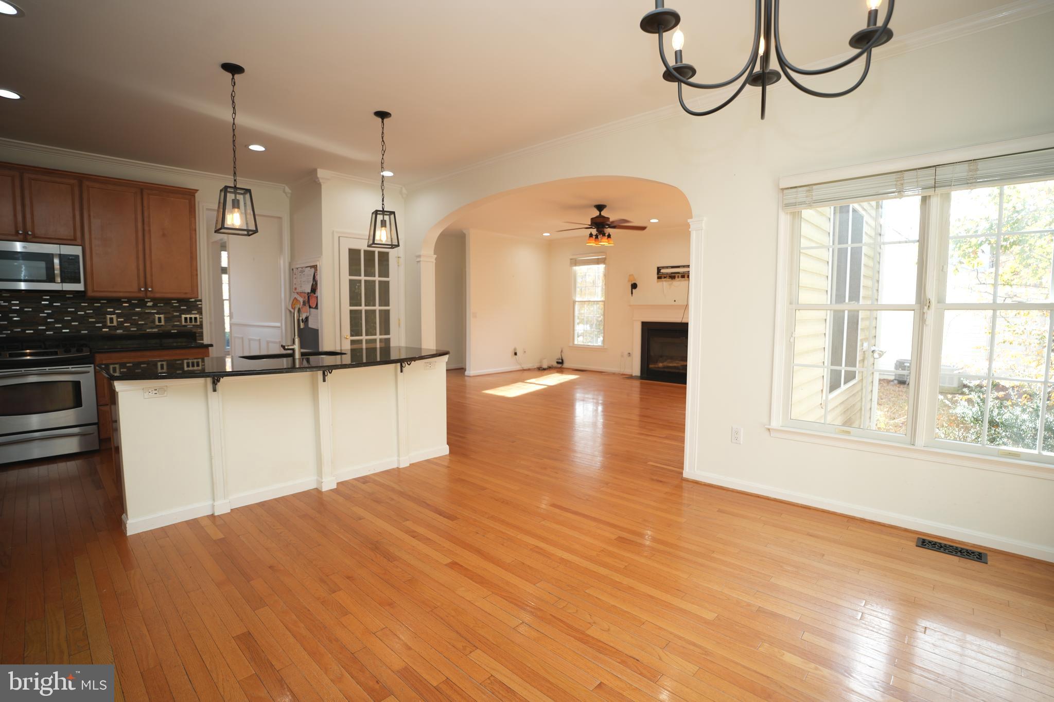 23293 Misty Pond Lane California, MD 20619 - Photo 11 of 35 a view of a kitchen with granite countertop a window and a wooden floor