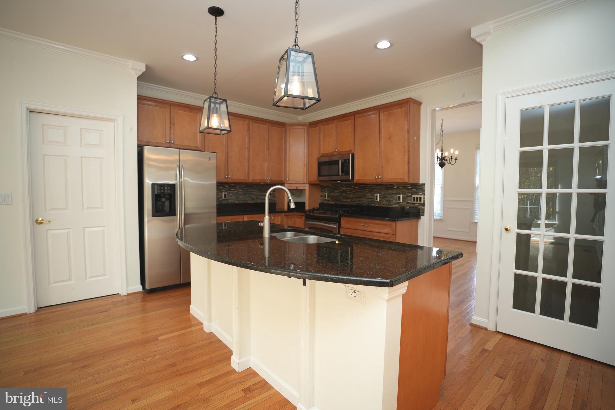 23293 Misty Pond Lane California, MD 20619 - Photo 12 of 35 a kitchen with stainless steel appliances granite countertop a sink a refrigerator and a granite counter tops