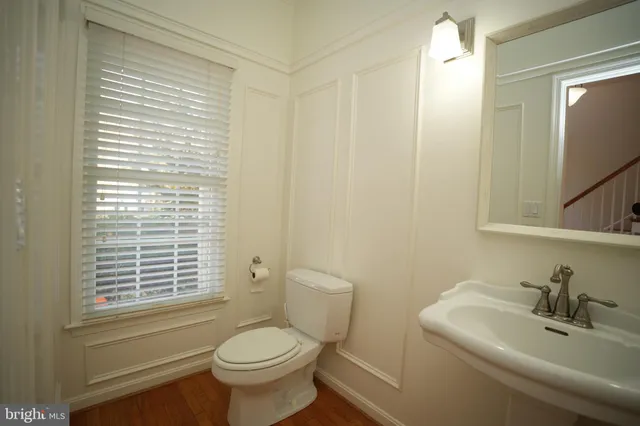 a bathroom with a toilet a sink and a window