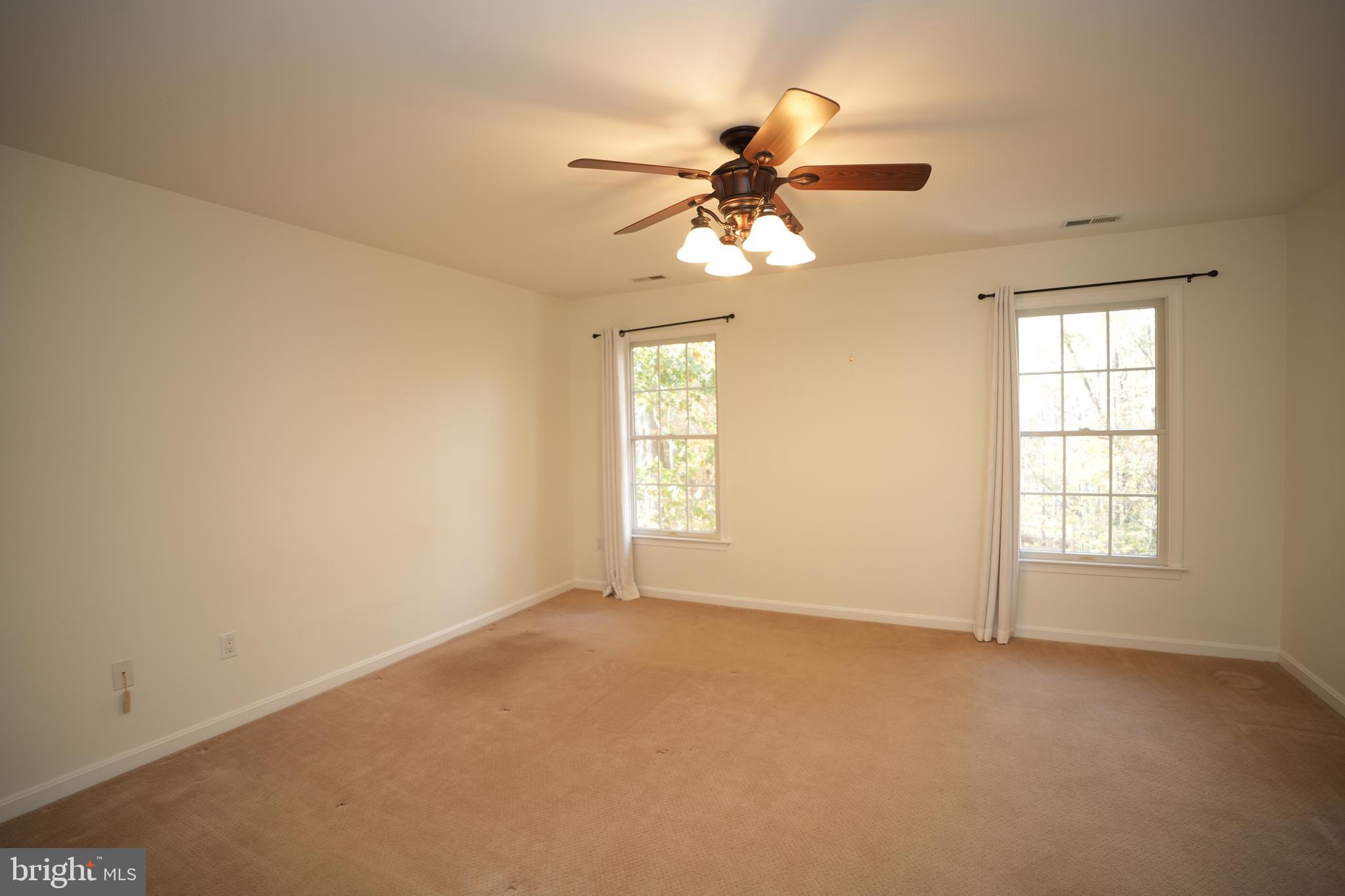 23293 Misty Pond Lane California, MD 20619 - Photo 15 of 35 an empty room with windows and fan