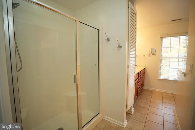 a bathroom with a shower and a tub