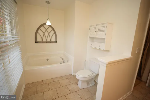 a bathroom with a toilet a sink and bathtub