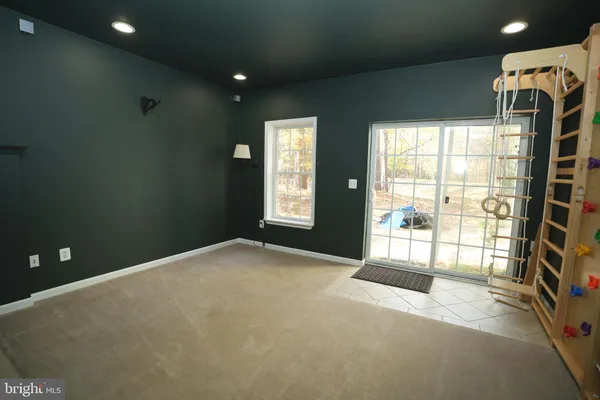a view of an empty room with a fireplace and a window