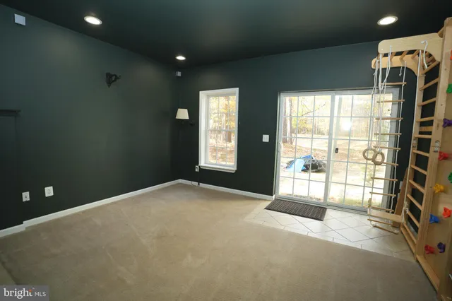 a view of an empty room with a fireplace and a window