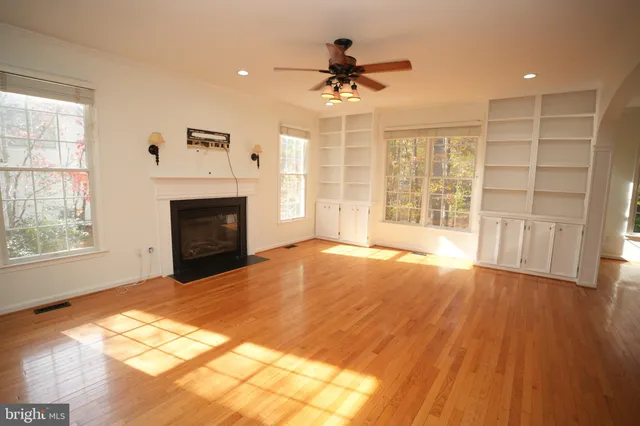 a view of an empty room with a fireplace and a window