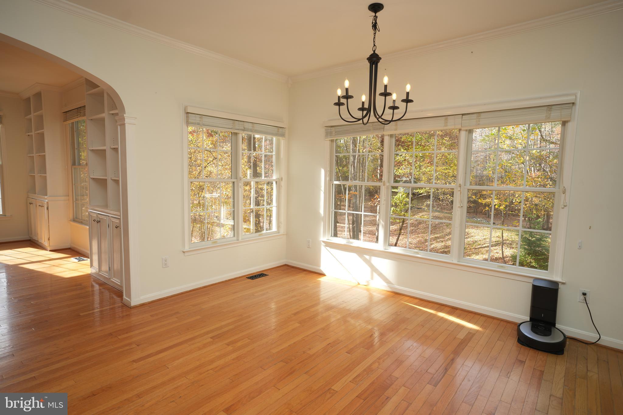23293 Misty Pond Lane California, MD 20619 - Photo 7 of 35 a view of an empty room with wooden floor and a window