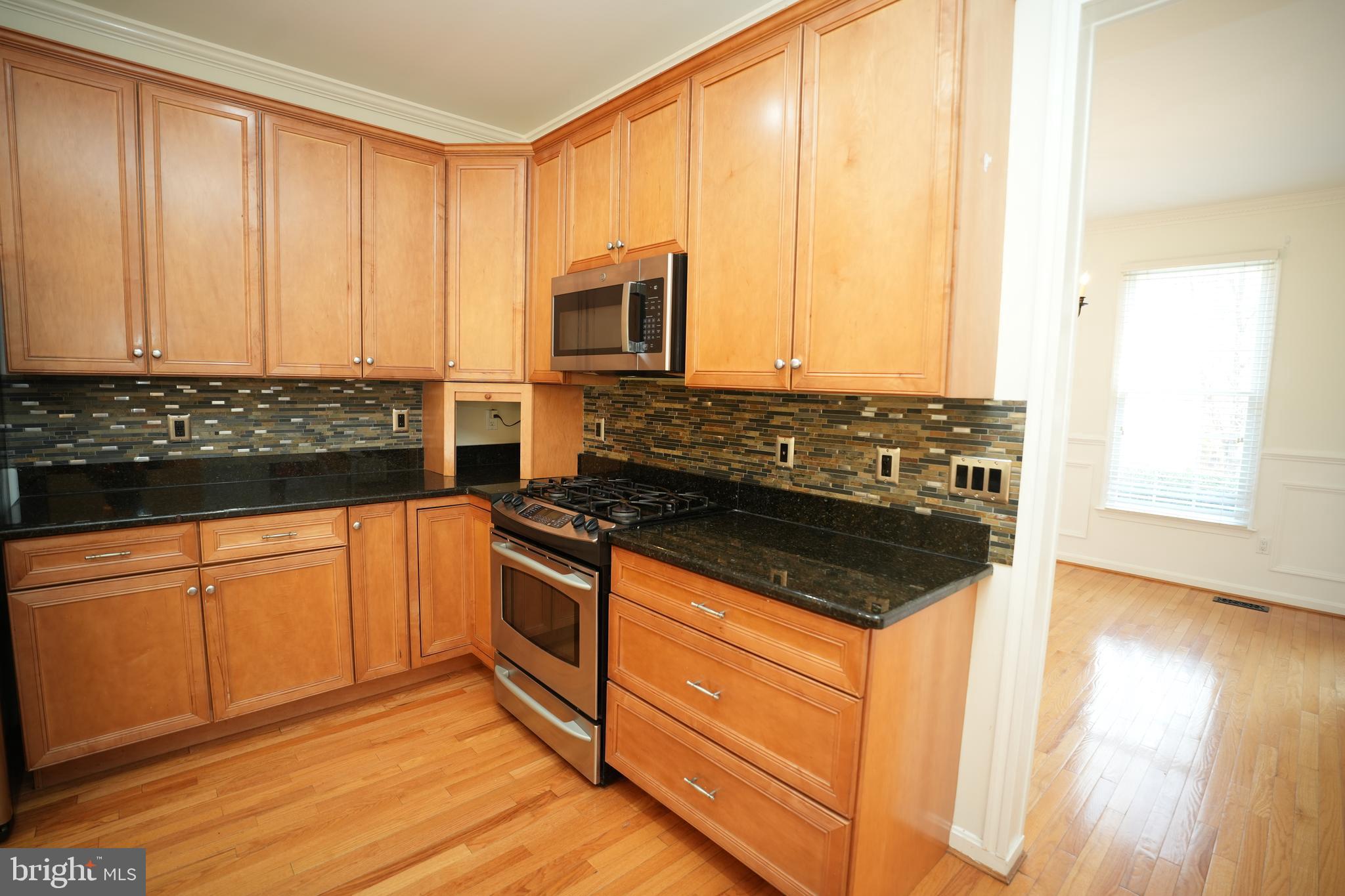 23293 Misty Pond Lane California, MD 20619 - Photo 10 of 35 a kitchen with stainless steel appliances granite countertop a stove a sink and a microwave