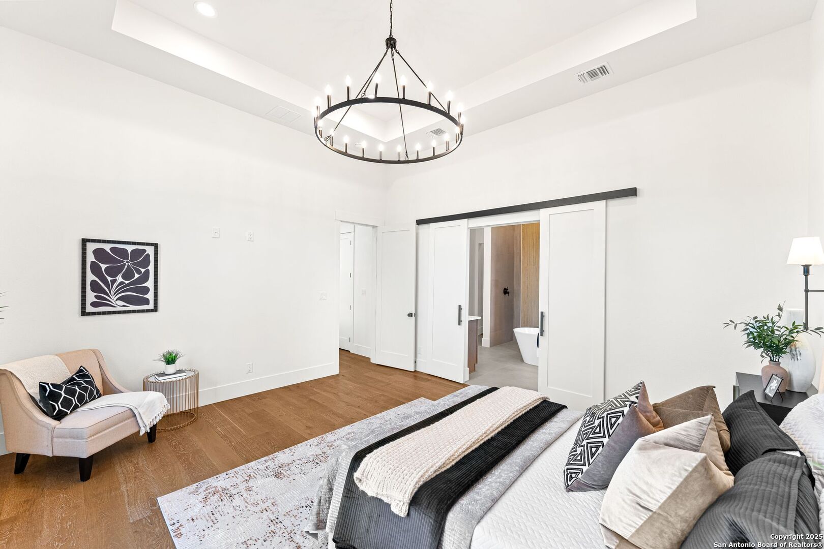 1202 Cielo Rio Drive Pipe Creek, TX 78063 - Photo 24 of 54 a bedroom with a bed and wooden floor