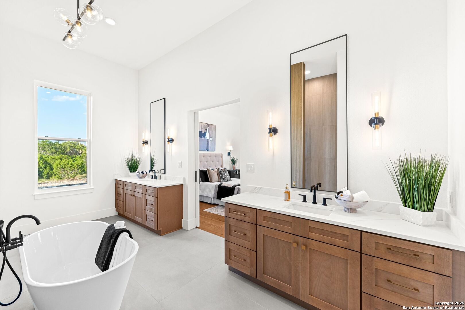 1202 Cielo Rio Drive Pipe Creek, TX 78063 - Photo 28 of 54 a bathroom with a double vanity sink bathtub and next to a window