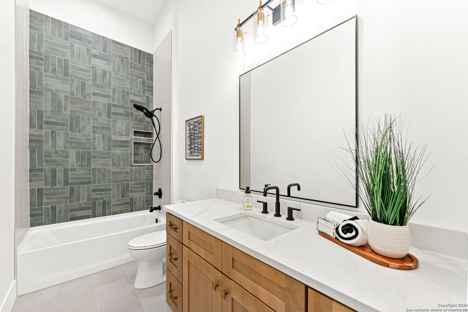 1202 Cielo Rio Drive Pipe Creek, TX 78063 - Photo 37 of 54 a bathroom with a granite countertop sink a toilet a mirror a vanity a bathtub and shower