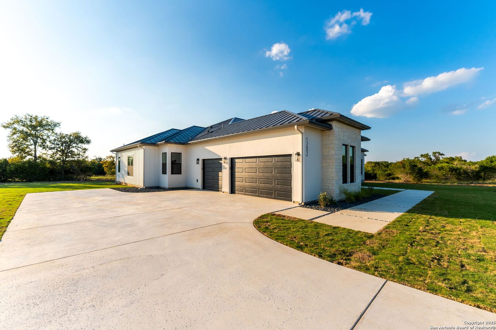 1202 Cielo Rio Drive Pipe Creek, TX 78063 - Photo 4 of 54 a front view of a house with a yard and garage