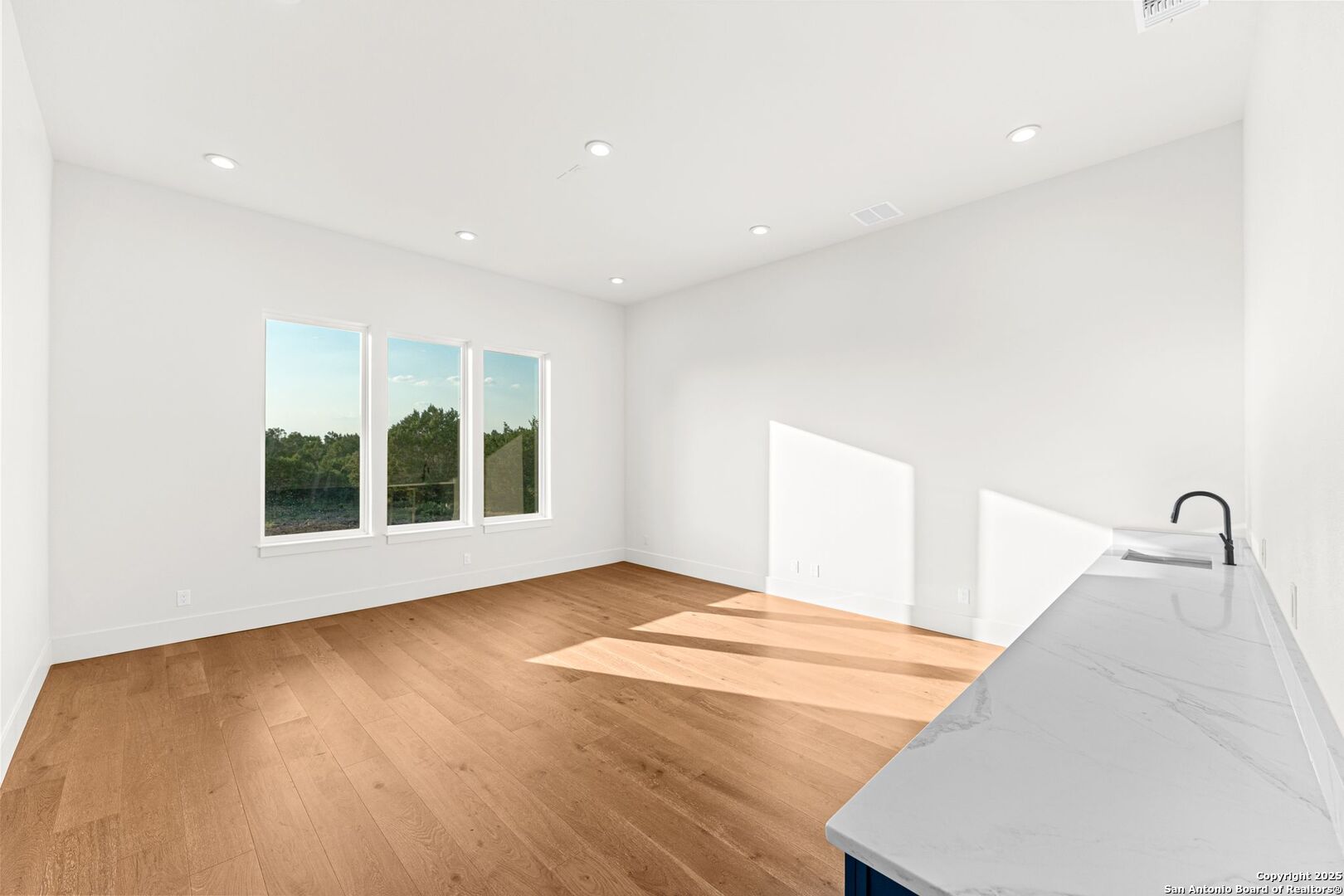 1202 Cielo Rio Drive Pipe Creek, TX 78063 - Photo 44 of 54 a view of an empty room with a window and wooden floor