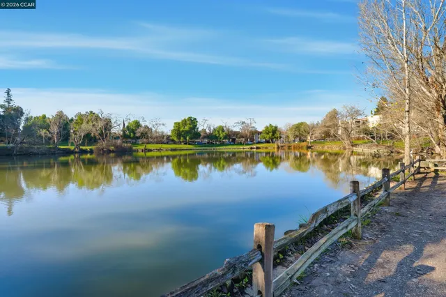 a view of a lake with houses in the back