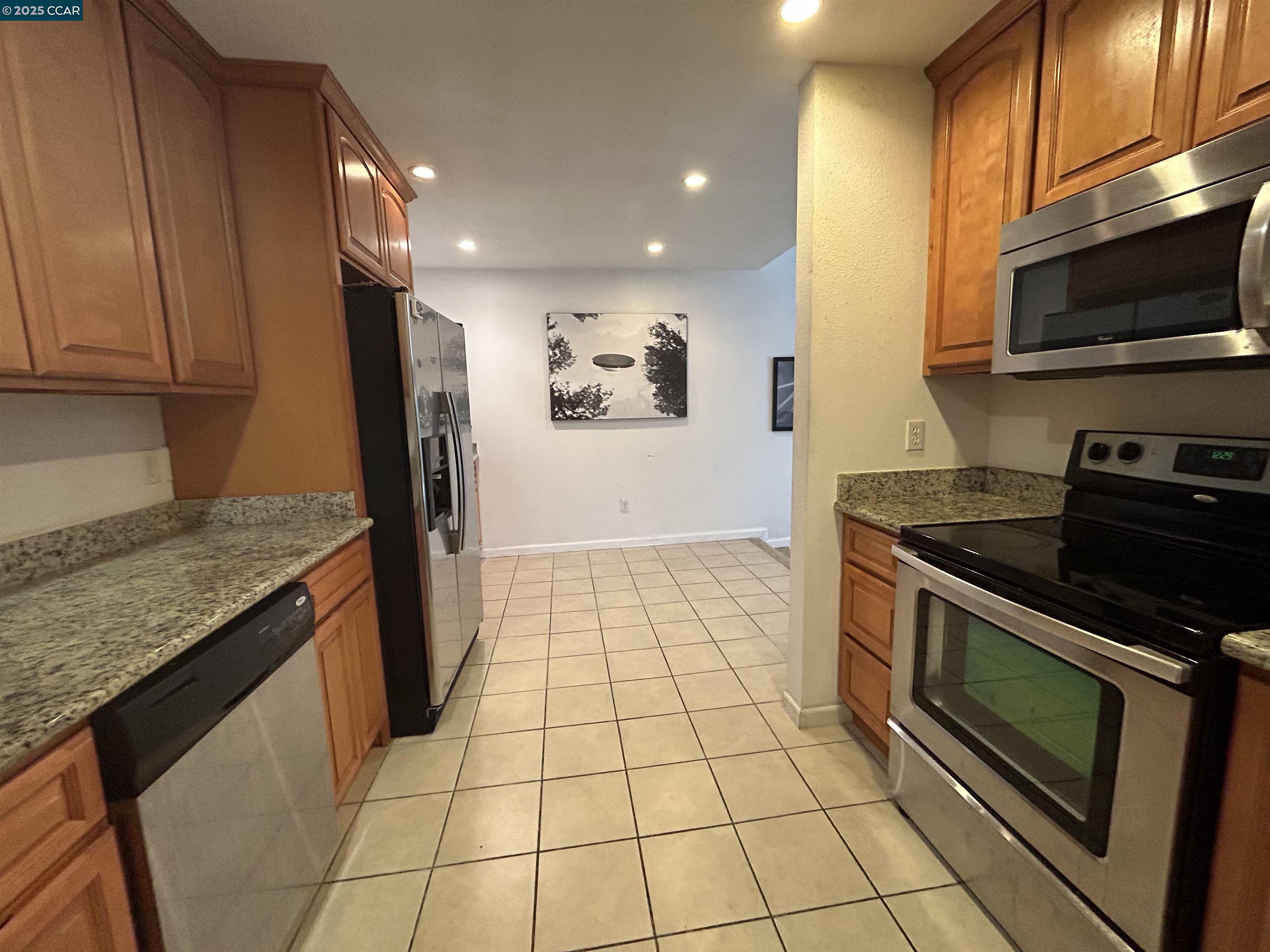 1591 Ellis Street, Unit 307 Concord, CA 94520 - Photo 5 of 13 a kitchen with a stove a sink and a microwave