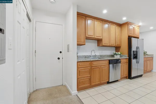 a kitchen with stainless steel appliances granite countertop a refrigerator and a sink