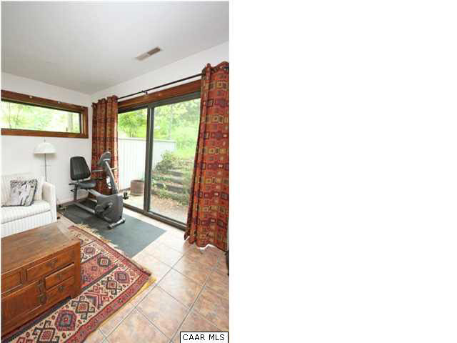1620 Keith Valley Road Charlottesville, VA 22901 - Photo 20 of 24 a living room with furniture and a floor to ceiling window