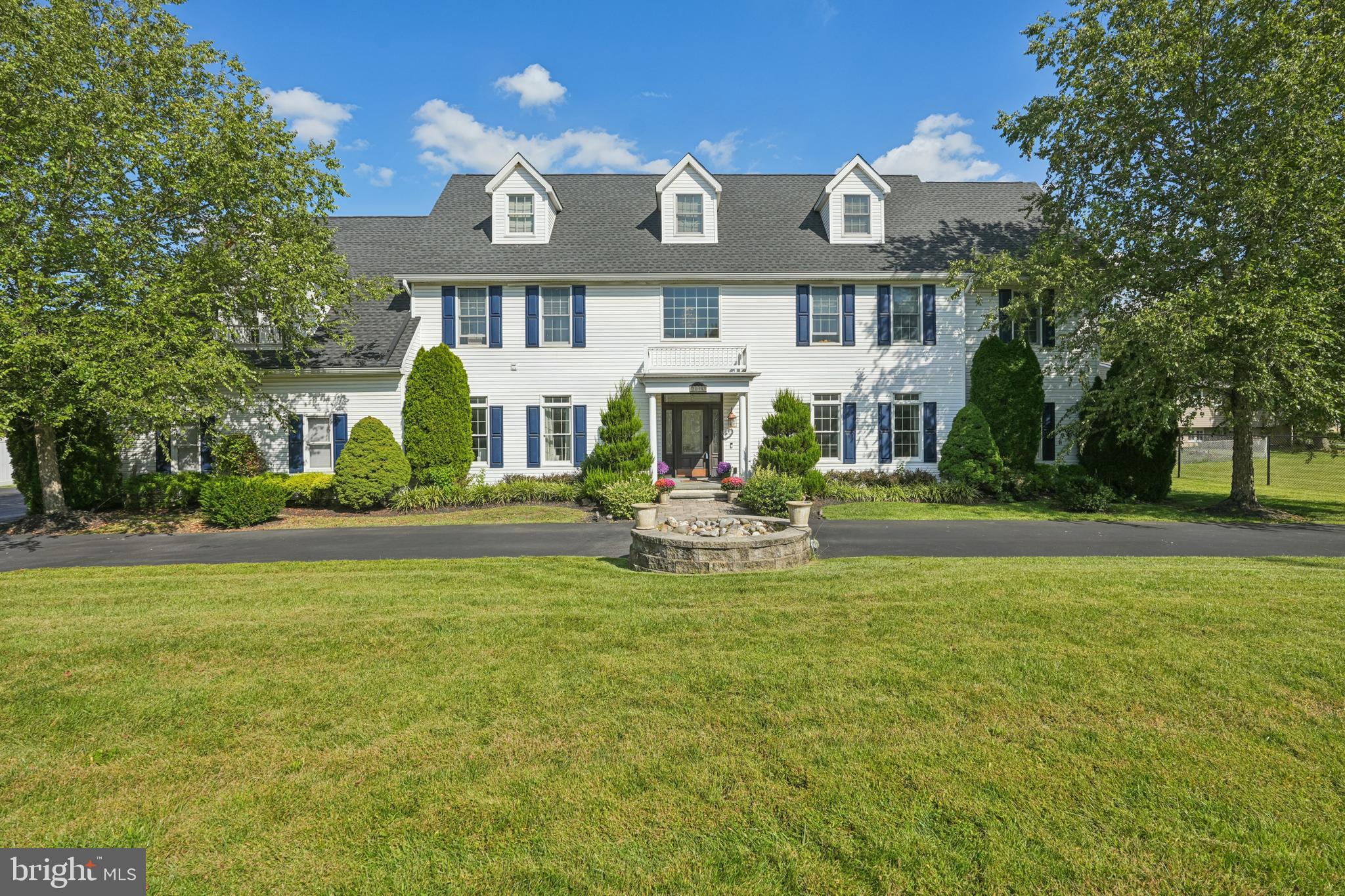 a front view of a house with swimming pool and porch
