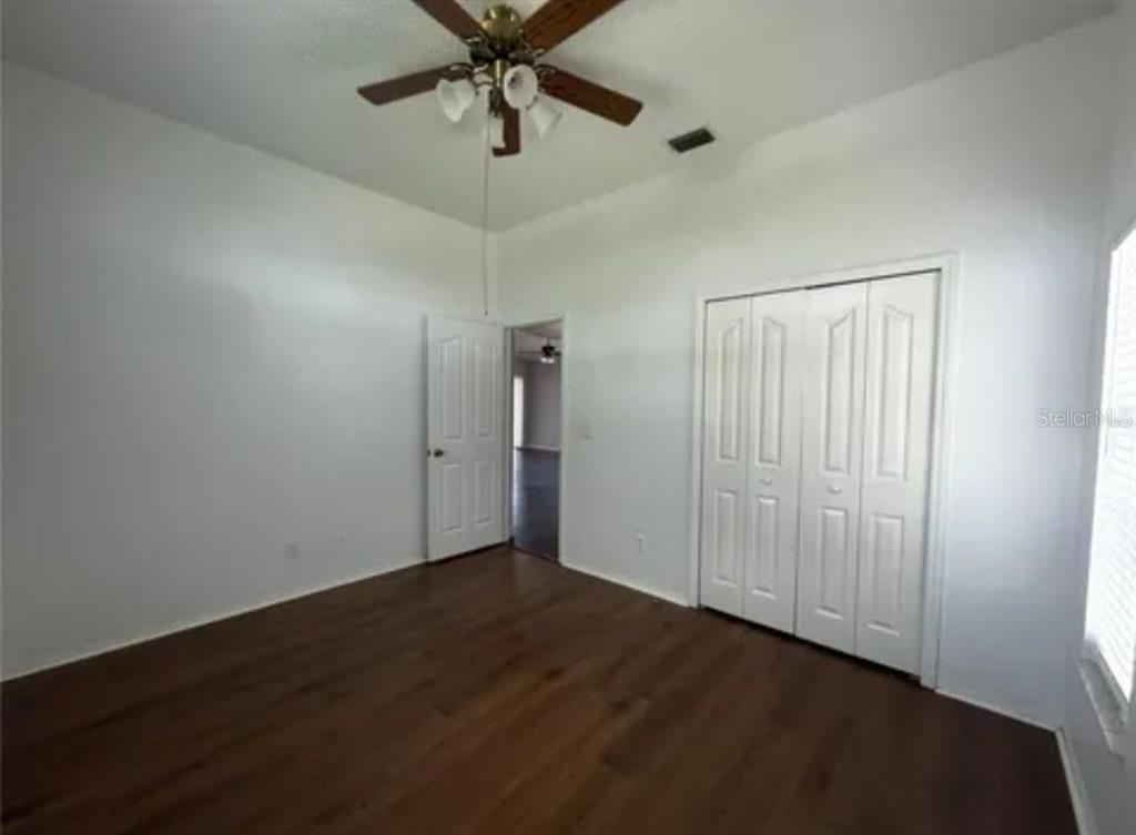9165 Eldridge Road Spring Hill, FL 34608 - Photo 12 of 17 wooden floor in an empty room