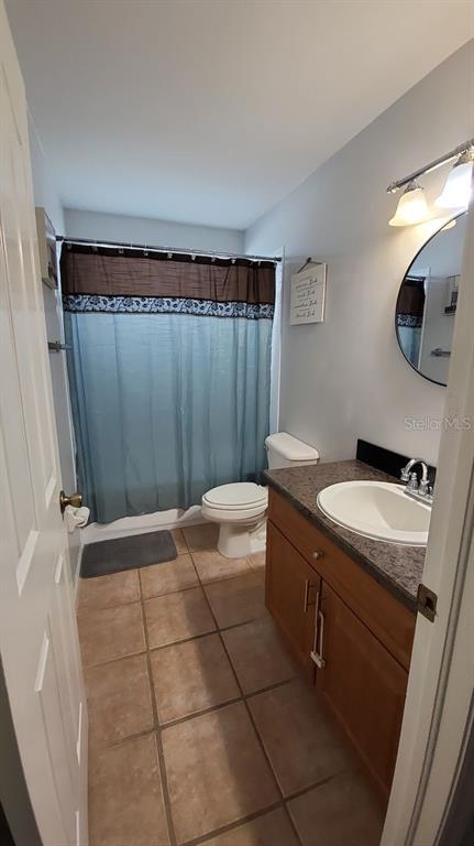 9165 Eldridge Road Spring Hill, FL 34608 - Photo 14 of 17 a bathroom with a granite countertop sink a toilet and shower