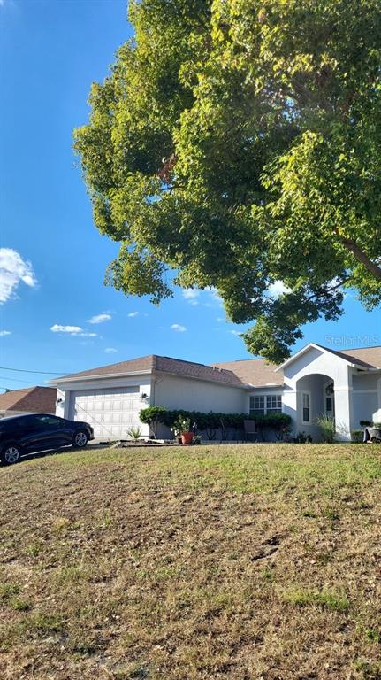 9165 Eldridge Road Spring Hill, FL 34608 - Photo 16 of 17 a front view of a house with a yard