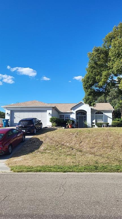 9165 Eldridge Road Spring Hill, FL 34608 - Photo 17 of 17 a front view of a house with a yard