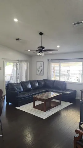 a living room with furniture pool table and window