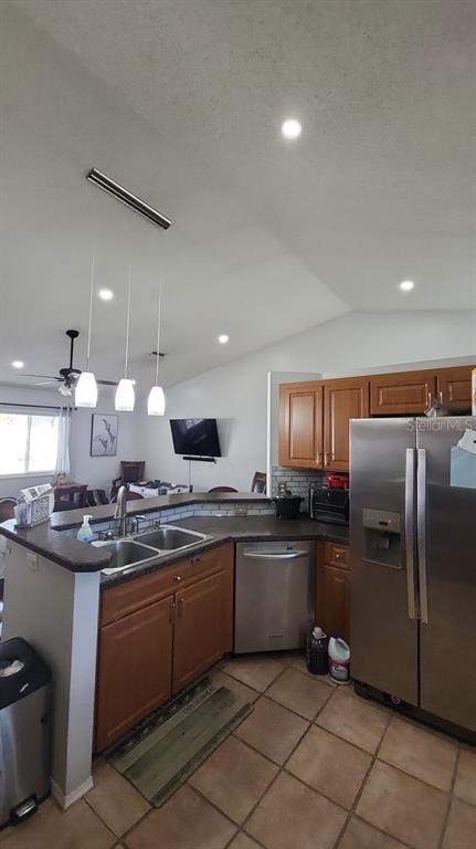 9165 Eldridge Road Spring Hill, FL 34608 - Photo 5 of 17 a kitchen with stainless steel appliances granite countertop a sink counter space cabinets and a refrigerator