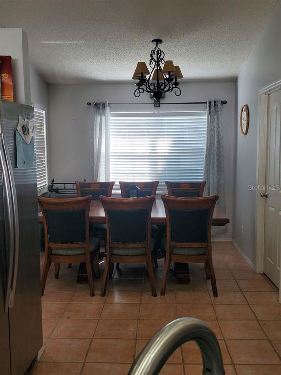 9165 Eldridge Road Spring Hill, FL 34608 - Photo 6 of 17 a view of a dining room with furniture and window
