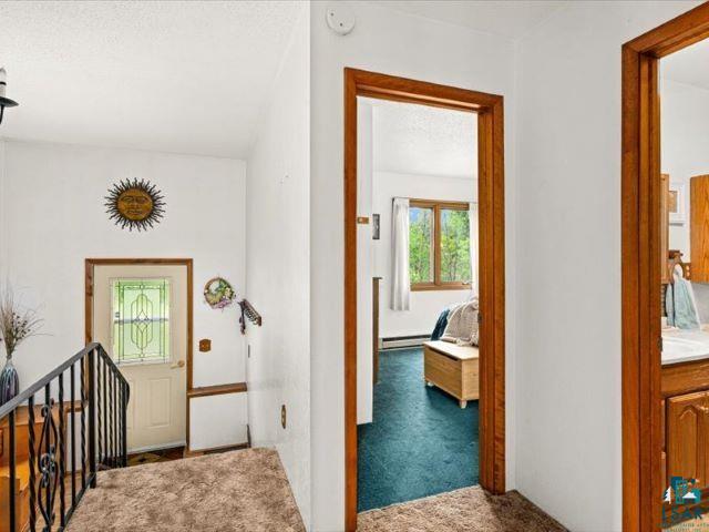 3616 Lavaque Road Hermantown, MN 55811 - Photo 31 of 43 Interior entryway with a leaded glass door, wrought iron stair railing, and wood trim