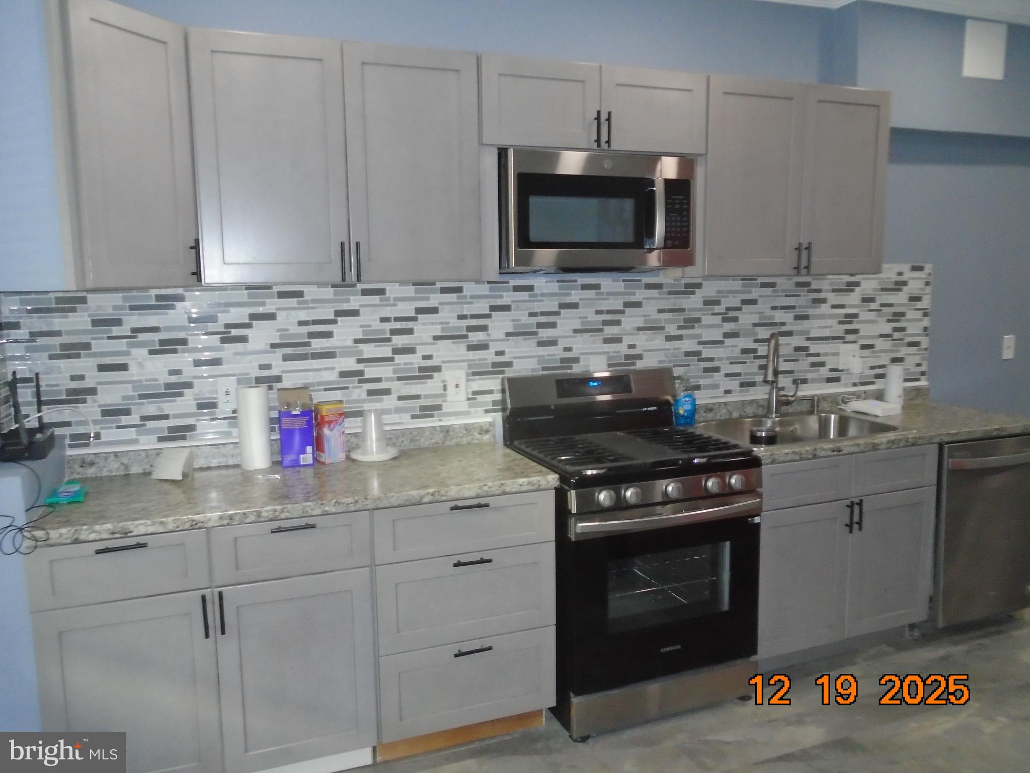2903 Jefferson Street Baltimore, MD 21205 - Photo 12 of 48 a kitchen with stainless steel appliances granite countertop a stove and a microwave